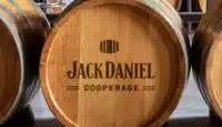Whiskey barrel on its side with Jack Daniel Cooperage logo burned onto the top